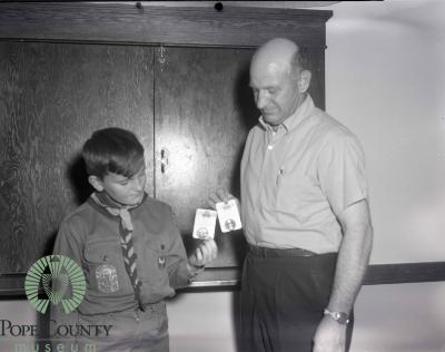 Unidentified Man and Boy from troop 423 holding two badges.