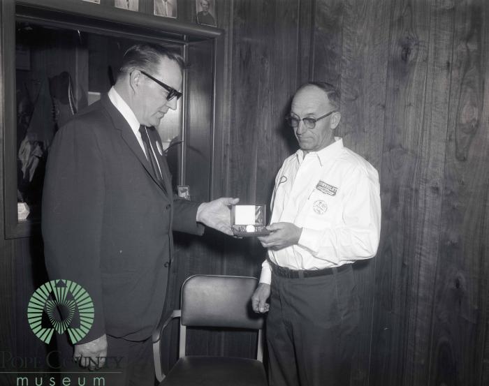 Bill Bodeker Receiving A Golden Watch from Harvey Gloege 