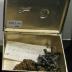 10 jacks and an old chain in a metal box with a horse drawn carriage on the lid