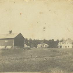 Black and white photograph of barn, windmill, sheds and farmhouse