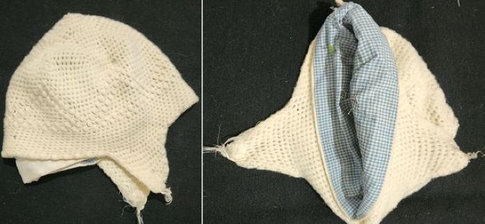 Ivory knitted baby cap lined with blue and white plaid cloth
