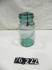 Quart size Ball canning jar with wire bale and glass lid.
