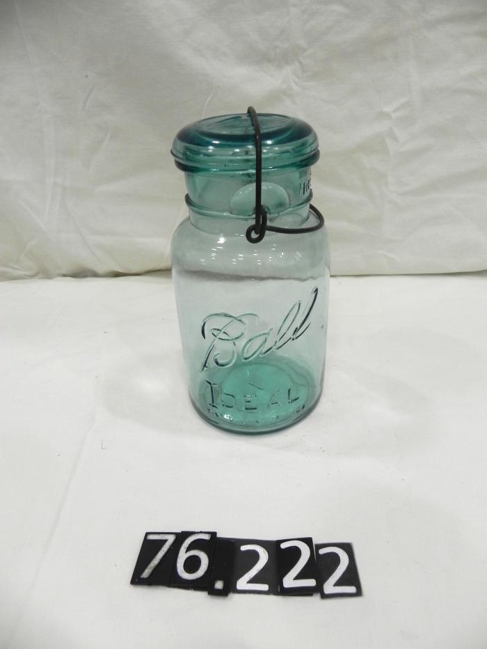 Quart size Ball canning jar with wire bale and glass lid.