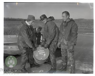 Conservation employees load boat with 30-gallon drum of Toxaphene