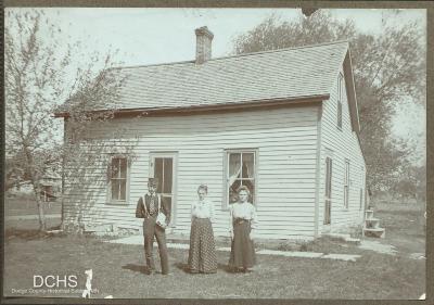 Black and white photograph of Gina, Leota and Fay Dewar in front of their house