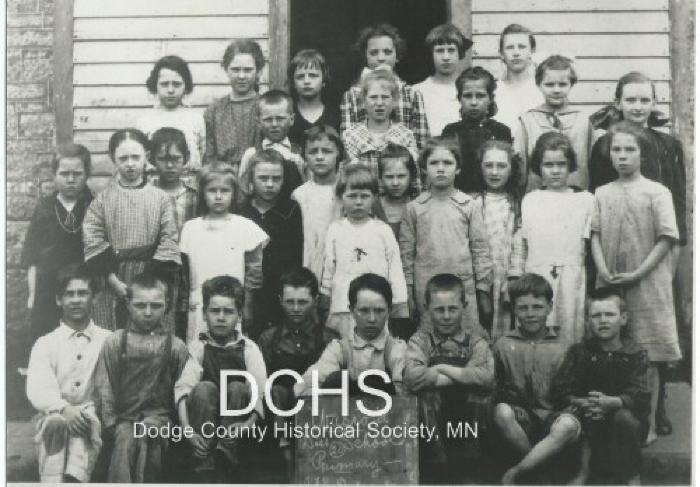 Black and white photograph of 31 students in front of the Wasioja school