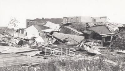Black and white photograph of multiple buildings damaged by tornado