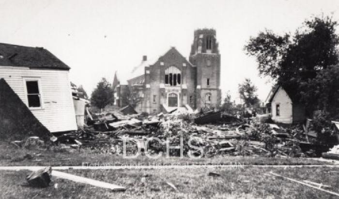 Black and white photograph of tornado debis in front of Trinity Church