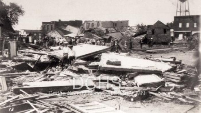 Black and white photograph of several heavily damaged buildings in Hayfield