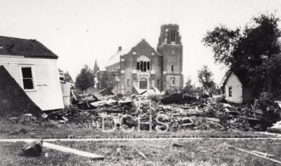 Black and white photograph of tornado debis in front of Trinity Church