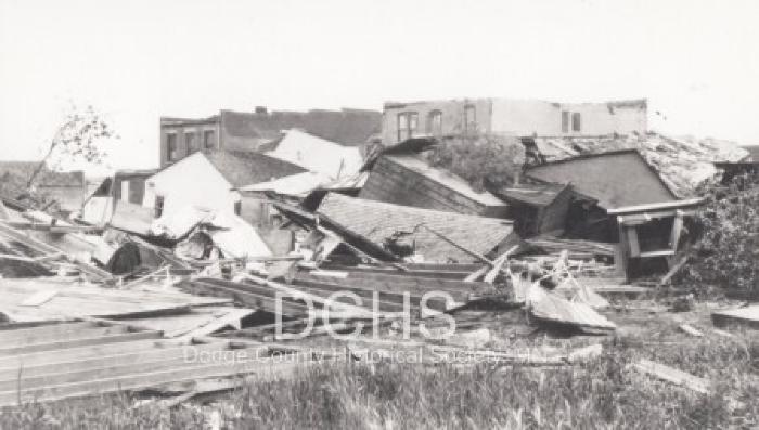 Black and white photograph of multiple buildings damaged by tornado