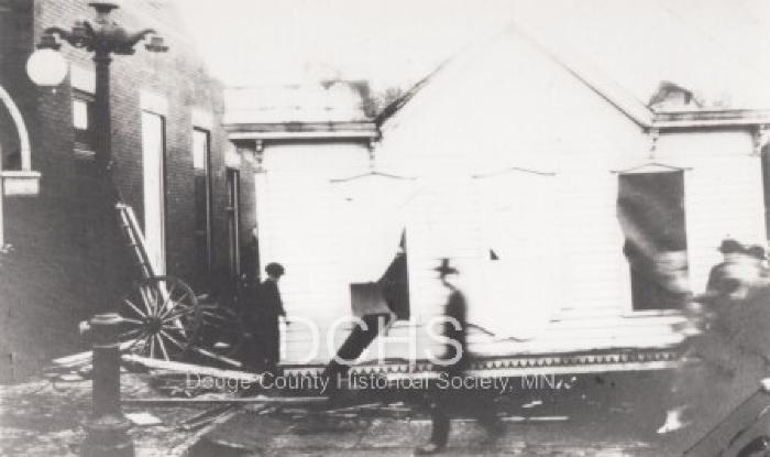 Photograph of building in middle of street from tornado