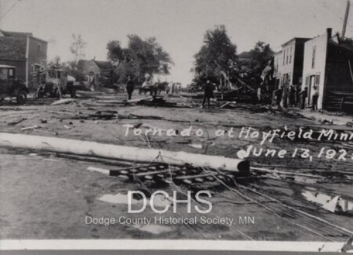 Black and white photograph of debris in street from tornado
