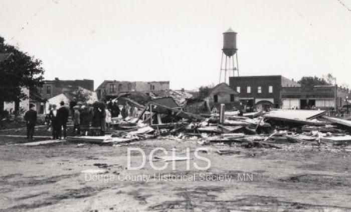 Black and white photograph of multiple buildings damaged by tornado