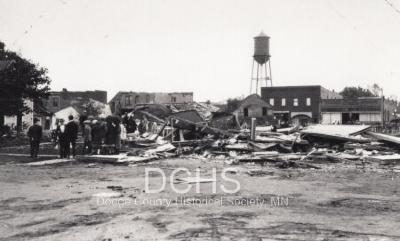 Black and white photograph of multiple buildings damaged by tornado