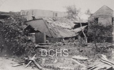 Black and white photograph of buildings damaged by tornado