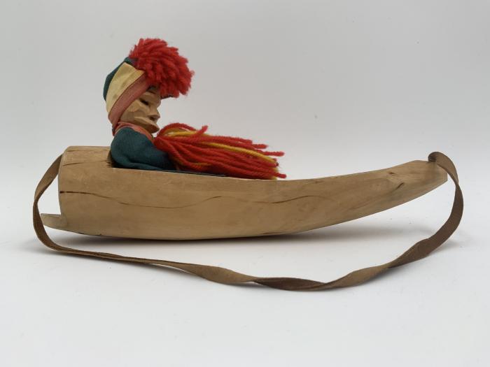 Sami Man in Sled: Wood Carving