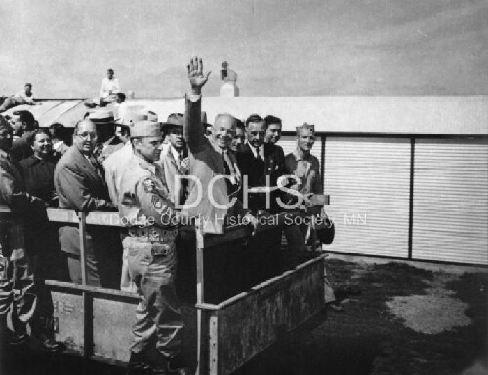 Black and white photograph of Eisenhower and group of men in back of wagon