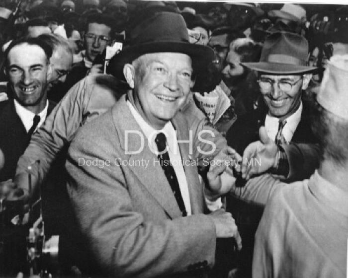 Black and white photograph of Eisenhower shaking hands with the crowd