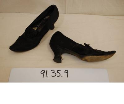 Woman’s black beaded high-heeled shoes