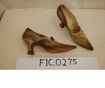Woman’s metallic gold pump shoes