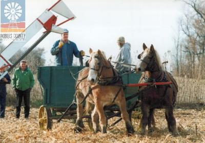 Wagon pulled by horses.