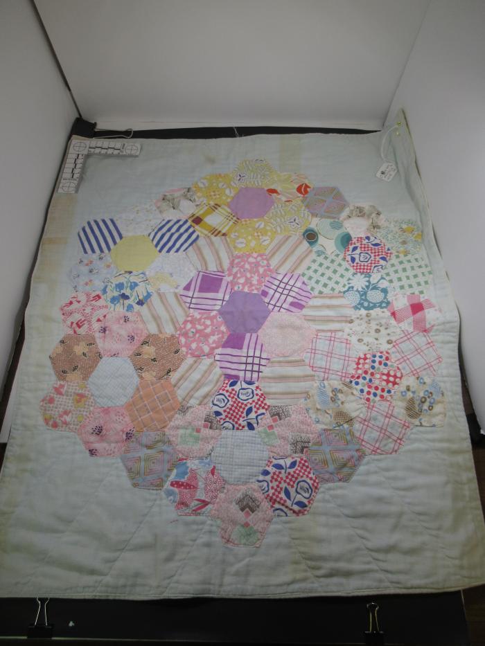 Doll Quilt-Accessory with with hexagonal pattern on front.