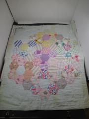 Doll Quilt-Accessory with with hexagonal pattern on front.
