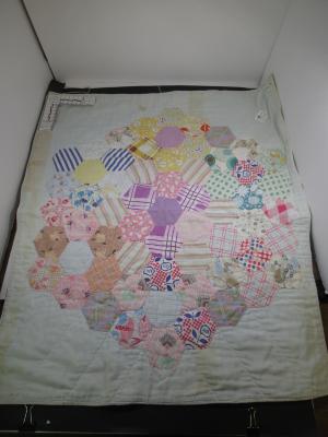 Doll Quilt-Accessory with with hexagonal pattern on front.